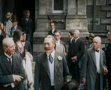 King George V Accompanied by a Group of Officials Emerging from a Building , 1924. Creator: British Pathe Ltd