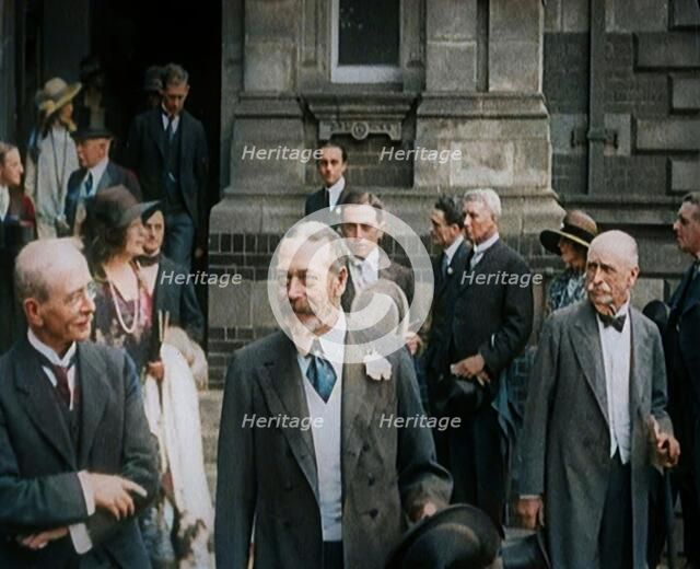 King George V Accompanied by a Group of Officials Emerging from a Building , 1924. Creator: British Pathe Ltd.