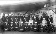 King George V and Queen Mary with the crew of HMY Victoria and Albert c1935. Creator: Kirk & Sons of Cowes