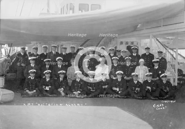 King George V and Queen Mary aboard 'HMY Victoria and Albert', with her crew, c1933. Creator: Kirk & Sons of Cowes.
