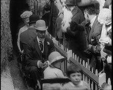 King George V and Queen Mary of the United Kingdom Sit in a Model Train As It Passes..., 1924. Creator: British Pathe Ltd