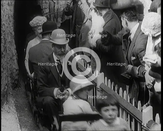 King George V and Queen Mary of the United Kingdom Sit in a Model Train As It Passes..., 1924. Creator: British Pathe Ltd.