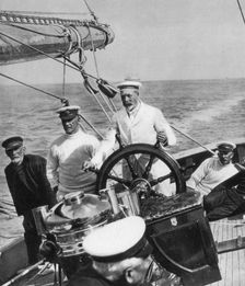 King George V at the helm of his yacht Britannia, c1930s