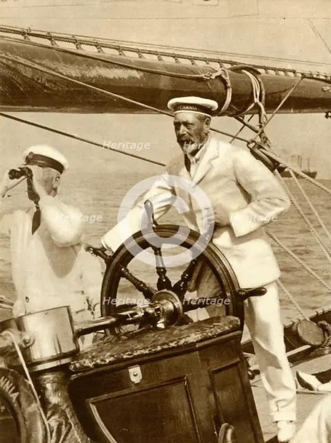 King George V at the wheel of of his yacht, Britannia, during Cowes Regatta week, 1924, (1935).   Creator: Unknown.