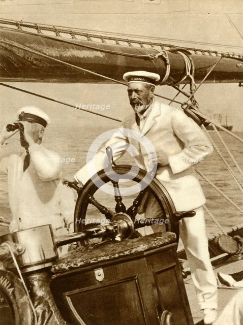 King George V at the wheel of of his yacht, Britannia, during Cowes Regatta week, 1924, (1935).   Creator: Unknown.