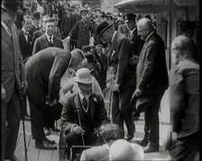 King George V of the United Kingdom Sitting On a Model Train With a Crowd of People Watching, 1924. Creator: British Pathe Ltd