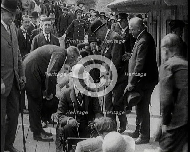 King George V of the United Kingdom Sitting On a Model Train With a Crowd of People Watching, 1924. Creator: British Pathe Ltd.