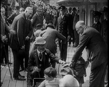King George V of the United Kingdom Sitting On a Model Train With a Crowd of People Watching, 1924. Creator: British Pathe Ltd