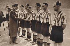King George VI and Queen Elizabeth attend the Association Football cup final , 1937