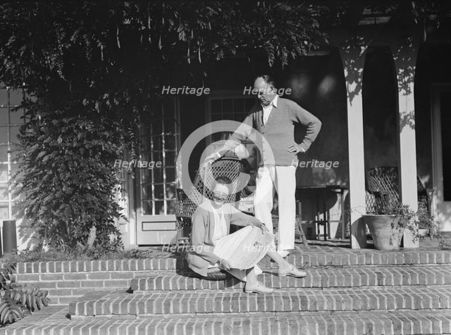 King, Hamilton, Mr. and Mrs., seated on the steps of their home, 1932 or 1933. Creator: Arnold Genthe.