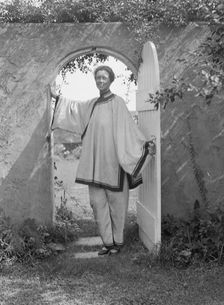King, Hamilton, Mrs., standing in a garden door, 1932 Creator: Arnold Genthe