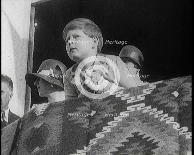 King Michael of Romania  Leans Over a Balcony. Behind Him are Two Female Civilians, 1924. Creator: British Pathe Ltd.