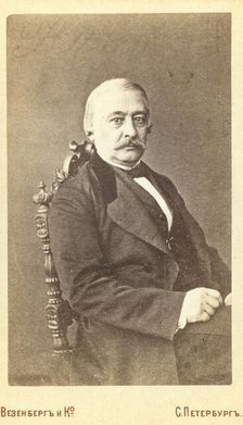 Kraevskii, Andrei Aleksandrovich, half-length portrait, seated, facing..., between 1880 and 1886. Creator: Unknown