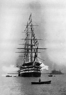 HMS Duke of Wellington firing a Royal Salute as flagship at Portsmouth, Hampshire, 1896.Artist: Symonds & Co