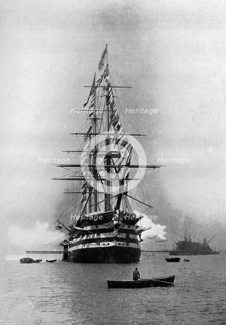 HMS 'Duke of Wellington' firing a Royal Salute as flagship at Portsmouth, Hampshire, 1896.Artist: Symonds & Co