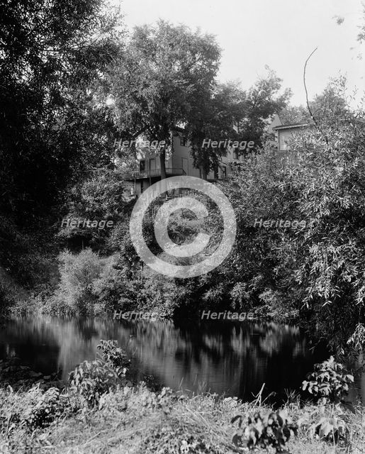 House above river, probably the Huron River, Ypsilanti, Mich., between 1900 and 1910. Creator: Unknown.