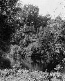 House above river, probably the Huron River, Ypsilanti, Mich., between 1900 and 1910. Creator: Unknown
