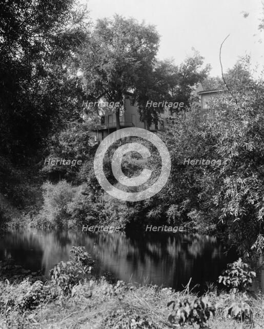 House above river, probably the Huron River, Ypsilanti, Mich., between 1900 and 1910. Creator: Unknown.