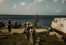 Housewives at the seashore waiting for the fishing boats to come in Frederiksted, V.I., 1941. Creator: Jack Delano