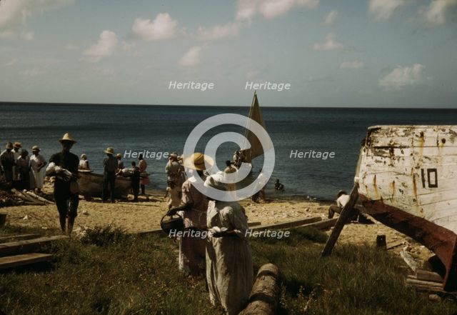 Housewives at the seashore waiting for the fishing boats to come in Frederiksted, V.I., 1941. Creator: Jack Delano.