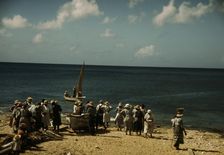 Housewives at the seashore waiting for the fishing boats to come in Frederiksted, V.I., 1941. Creator: Jack Delano