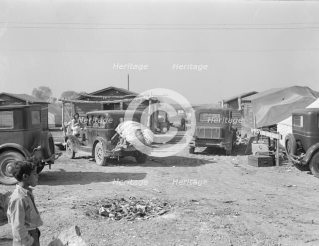 Housing for migratory workers in cotton, five miles north of Corcoran, California, 1936. Creator: Dorothea Lange.
