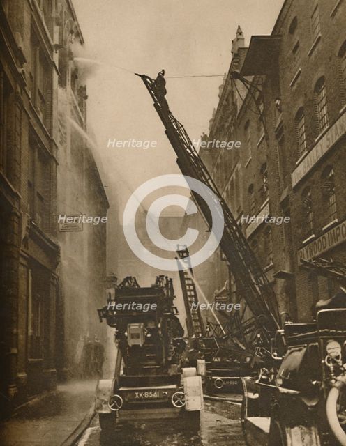 'How The London Fire Brigade Comes To Grips With Its Enemy', c1935. Creator: Unknown.