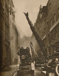 How The London Fire Brigade Comes To Grips With Its Enemy c1935. Creator: Unknown