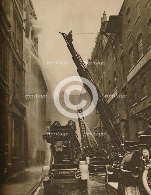 'How The London Fire Brigade Comes To Grips With Its Enemy', c1935. Creator: Unknown.