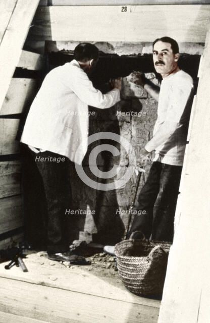 Howard Carter and a colleague excavating a tomb in the Valley of the Kings, Egypt, 1922. Artist: Harry Burton