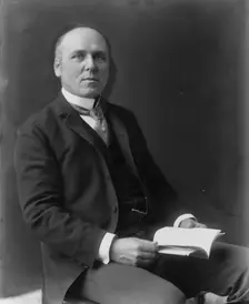 Howard Pyle, three-quarter length portrait, seated, facing slightly right, c1897. Creator: Frances Benjamin Johnston
