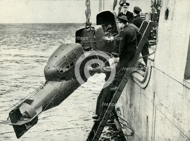Hoisting a Chariot manned torpedo on board a ship, World War II, 1945. Creator: Unknown.