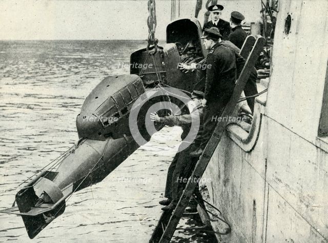 Hoisting a Chariot manned torpedo on board a ship, World War II, 1945. Creator: Unknown.