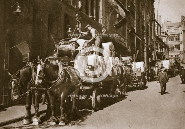 Hoisting the paper into a newspaper office, 20th century. Creator: Unknown.