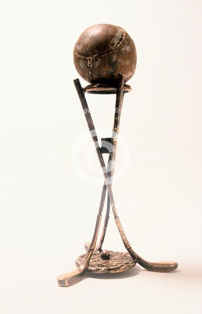 Hole-in-one silver holder with a featherie ball, c1900. Creator: Unknown.