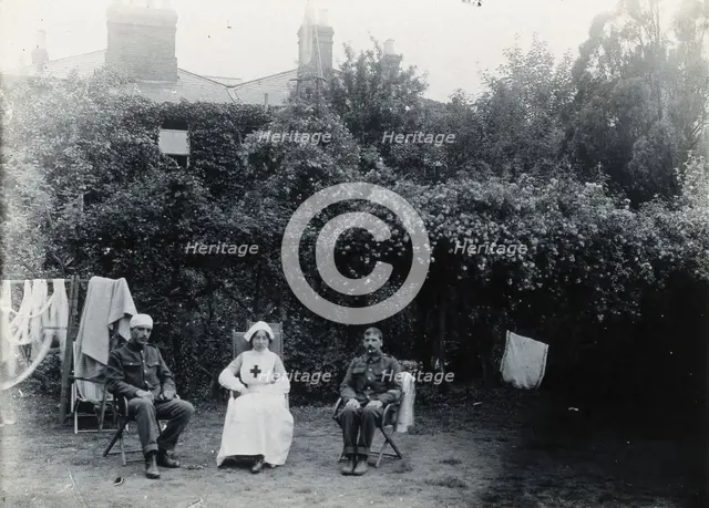Holmleigh Auxiliary Military Hospital, Harrow: a nurse and two soldiers, one of whom has..., c1922. Creator: Unknown.