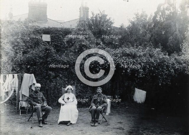 Holmleigh Auxiliary Military Hospital, Harrow: a nurse and two soldiers, one of whom has..., c1922. Creator: Unknown.