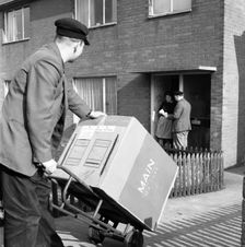 Home delivery of a cooker, Darfield, Barnsley, South Yorkshire, 1963. Creator: Michael Walters