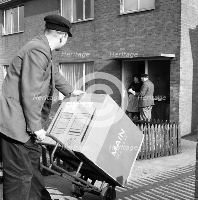 Home delivery of a cooker, Darfield, Barnsley, South Yorkshire, 1963. Creator: Michael Walters.