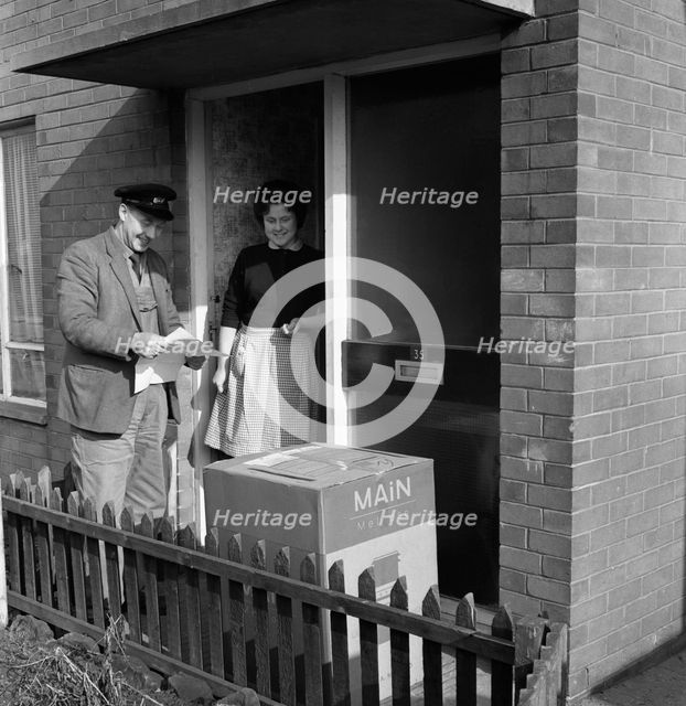 Home delivery of a cooker, Darfield, Barnsley, South Yorkshire, 1963. Creator: Michael Walters.