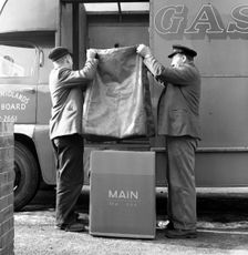 Home delivery of a cooker, Darfield, Barnsley, South Yorkshire, 1963. Creator: Michael Walters