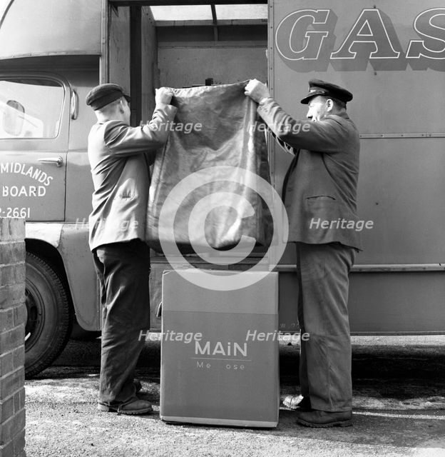 Home delivery of a cooker, Darfield, Barnsley, South Yorkshire, 1963. Creator: Michael Walters.