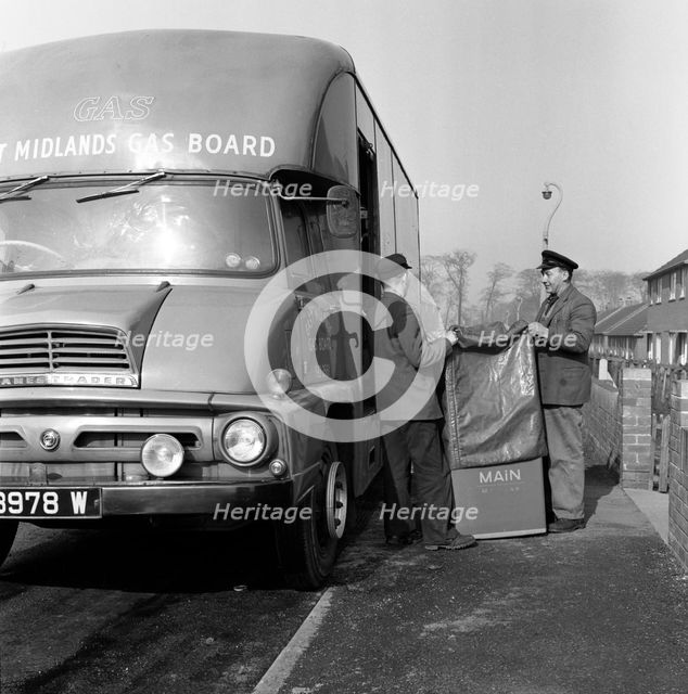 Home delivery of a cooker, Darfield, Barnsley, South Yorkshire, 1963. Creator: Michael Walters.