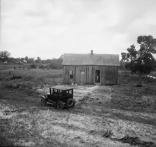 Home in a district from which many families immigrate West, near Sallisaw, Oklahoma, 1938. Creator: Dorothea Lange