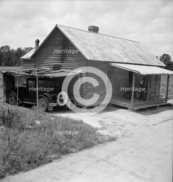 Home of Negro tobacco tenant with addition of improvised garage, Wake County, North Carolina, 1939. Creator: Dorothea Lange.