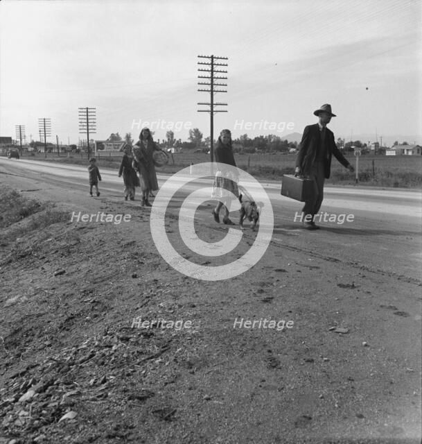 Homeless family of seven, walking the highway..., on U.S. 99, near Brawley, Imperial County, 1939. Creator: Dorothea Lange.