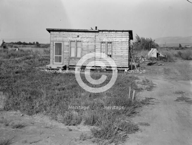 Homes are built bit by bit with whatever materials are available, Yakima,Washington, 1939. Creator: Dorothea Lange.