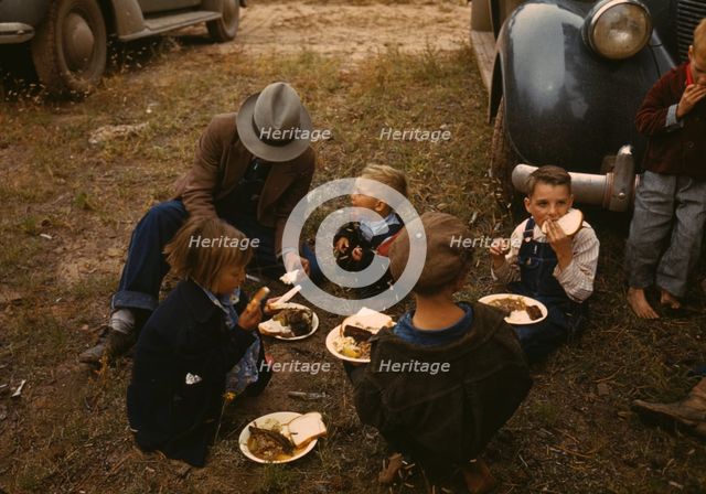 Homesteader and his children eating barbeque at the Pie Town, New Mexico Fair, 1940. Creator: Russell Lee.