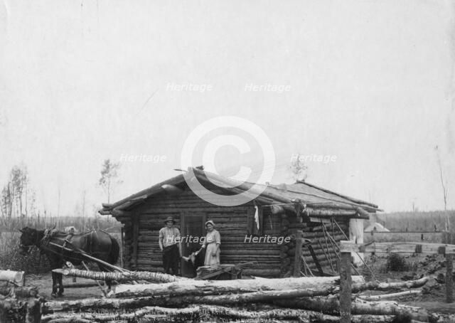 Homesteaders and their home, between c1900 and c1930. Creator: Unknown.