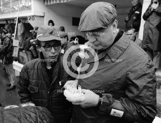 Honda technicians selecting the appropriate plugs. Artist: Unknown
